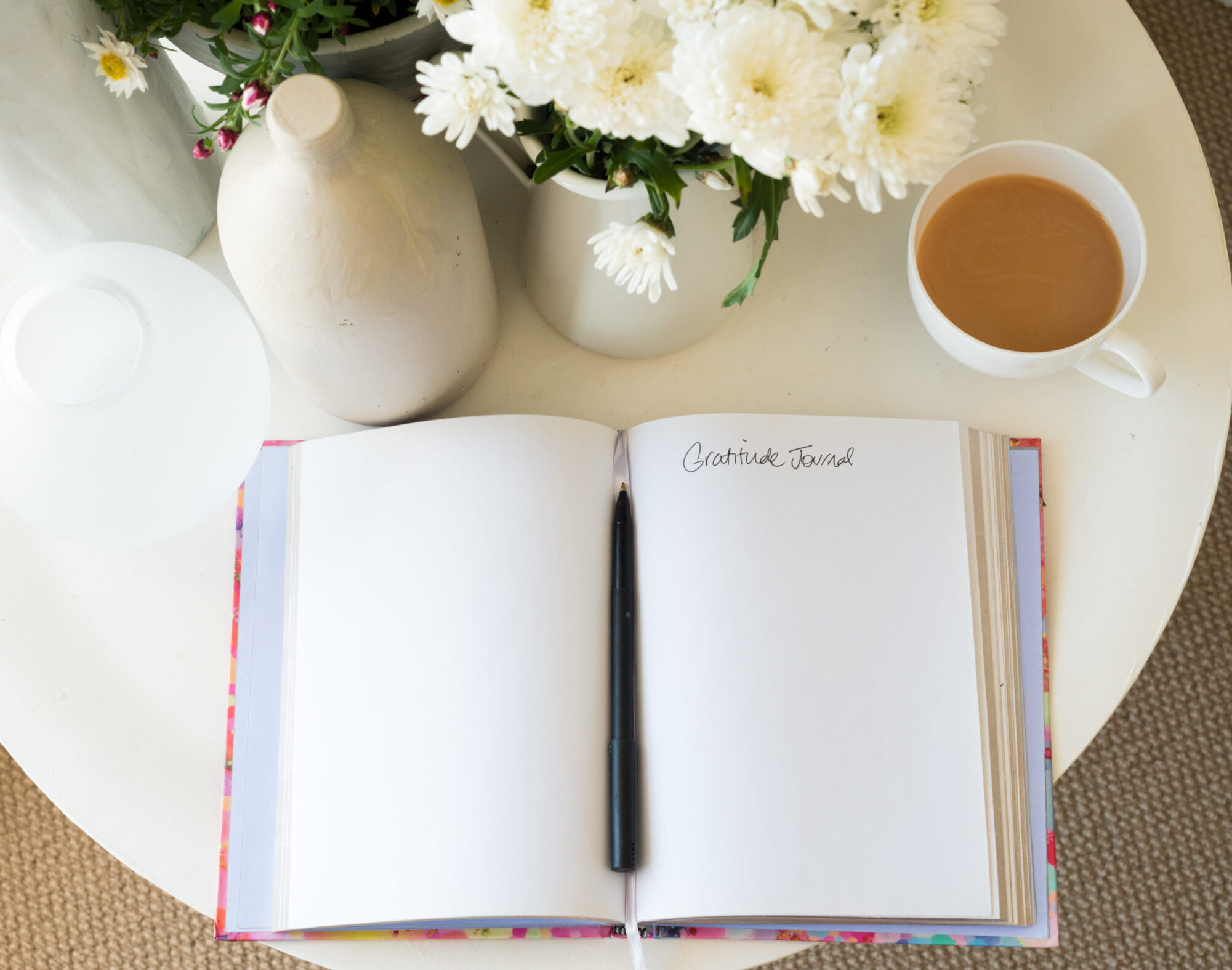 gratitude journal with tea and flowers